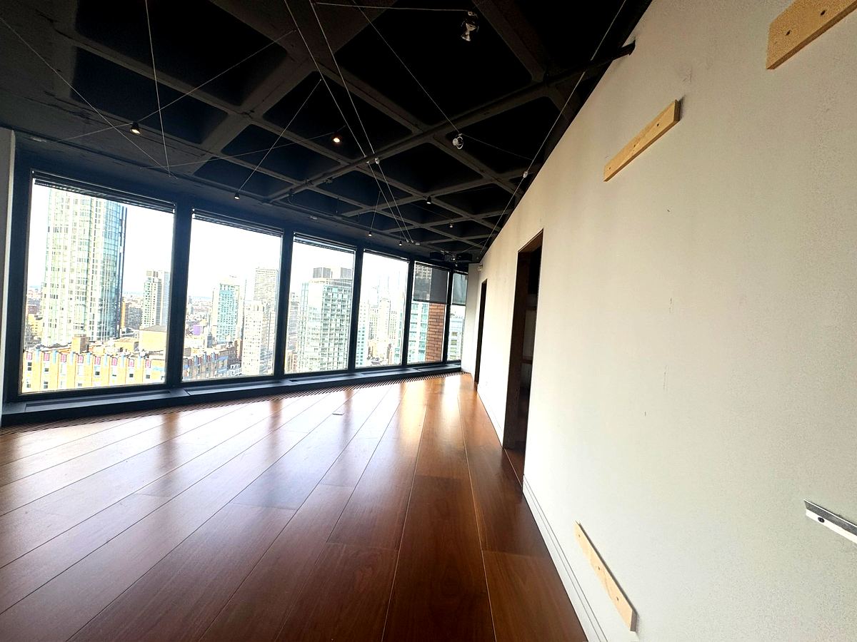 Hardwood floors and north-facing city views in the loft office at 3 Park Avenue 32nd floor