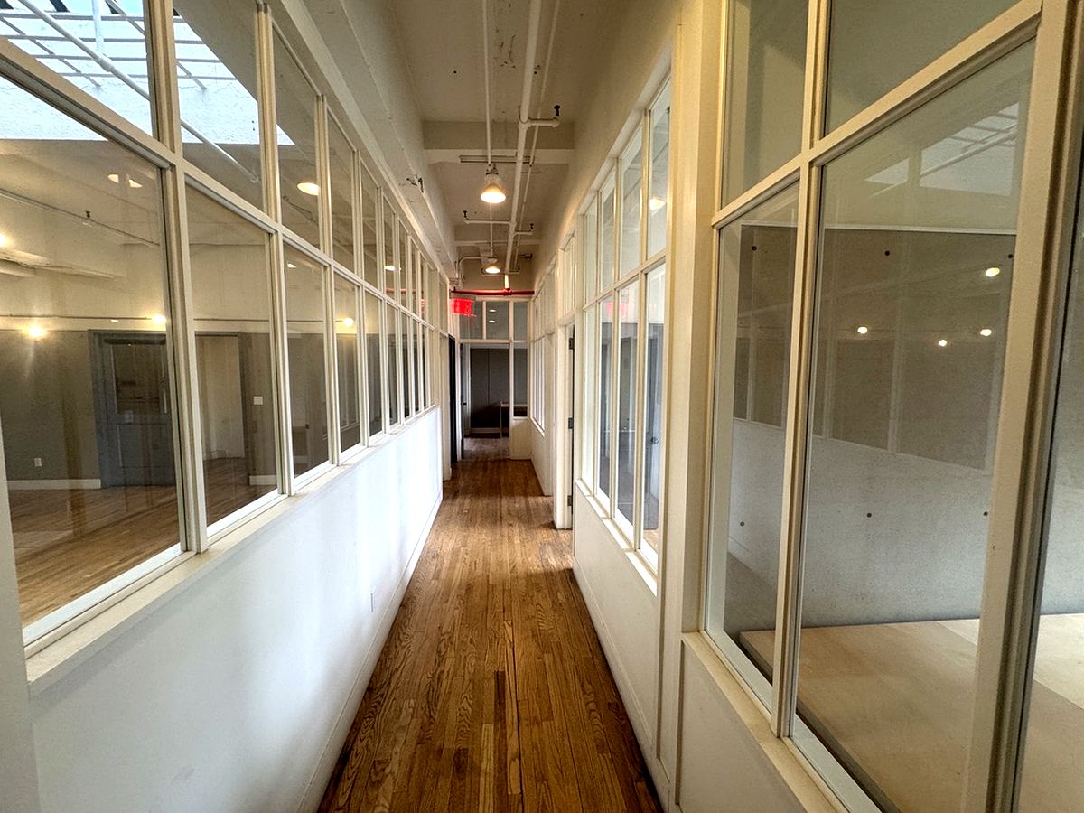 Glass-walled office corridor with hardwood floors, 12th floor at 7 West 30th Street