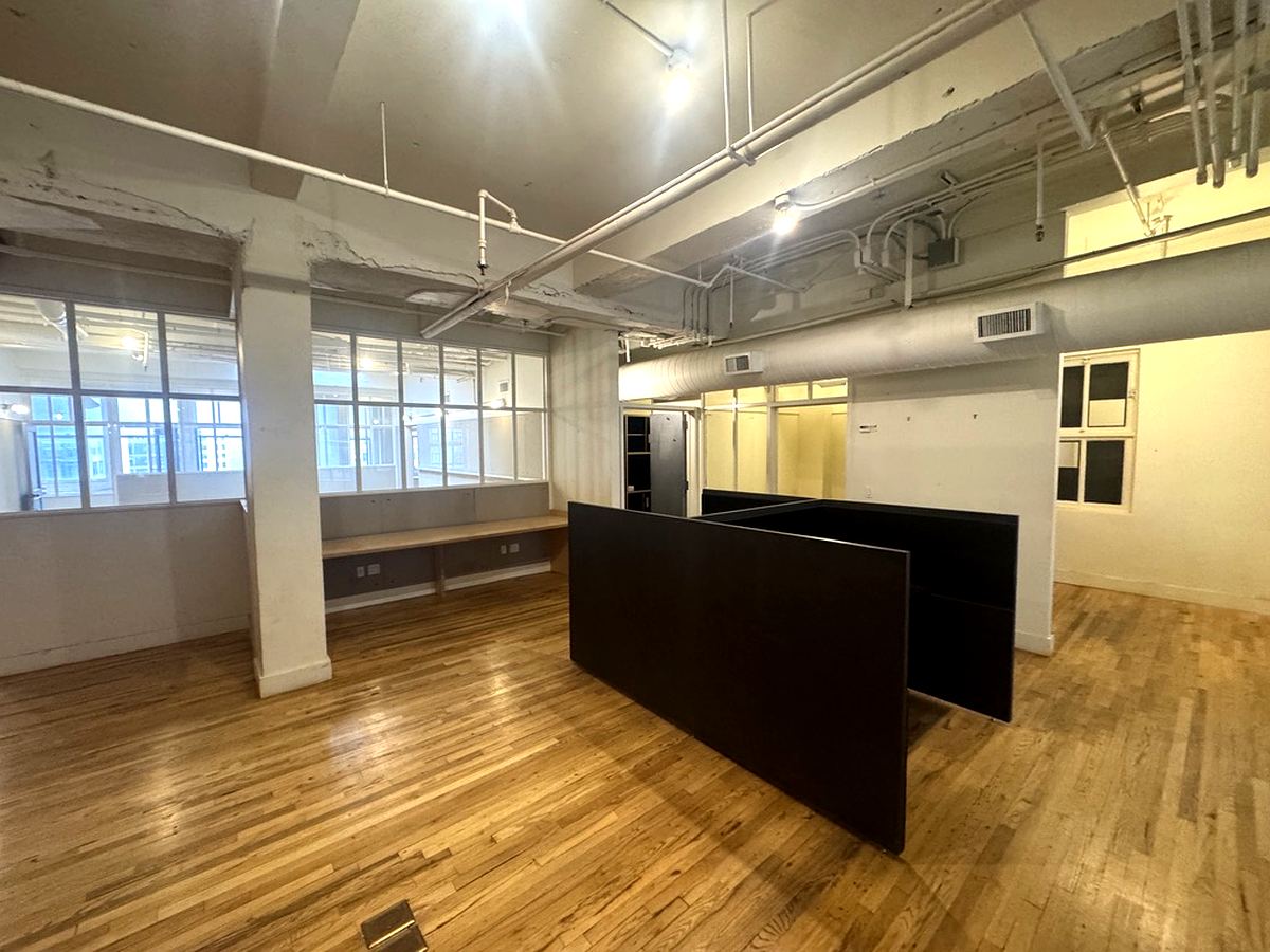 Open area with glass-wall offices and hardwood floors, 12th floor at 7 West 30th Street