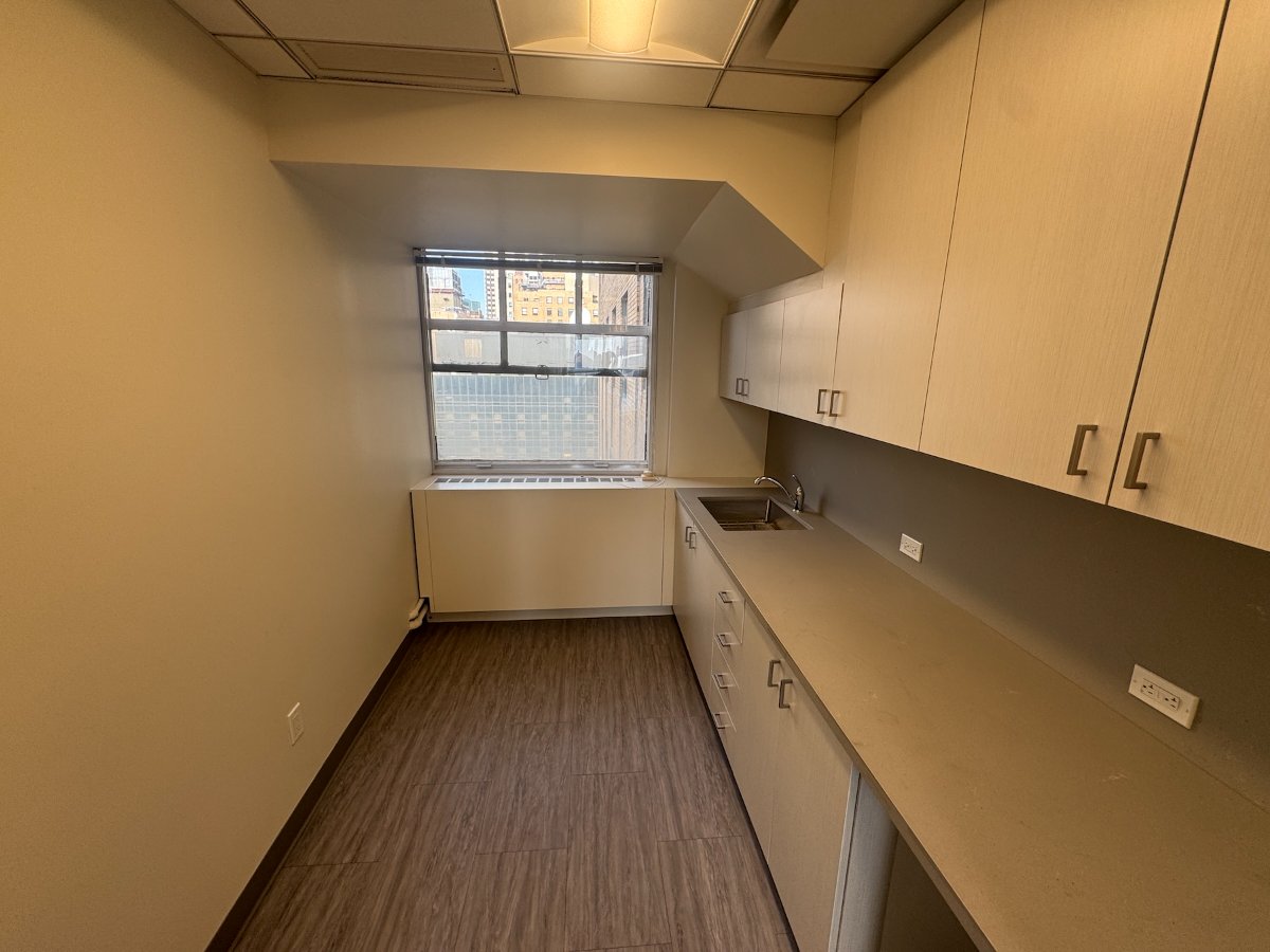 Private office with built-in cabinetry and city views at 122 East 42nd Street