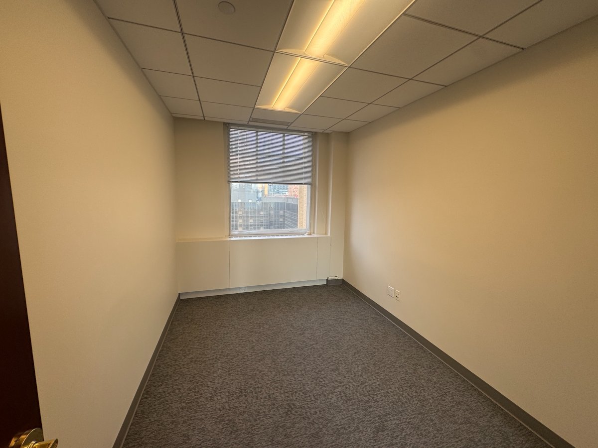 Windowed office with carpet and city skyline views at 122 East 42nd Street