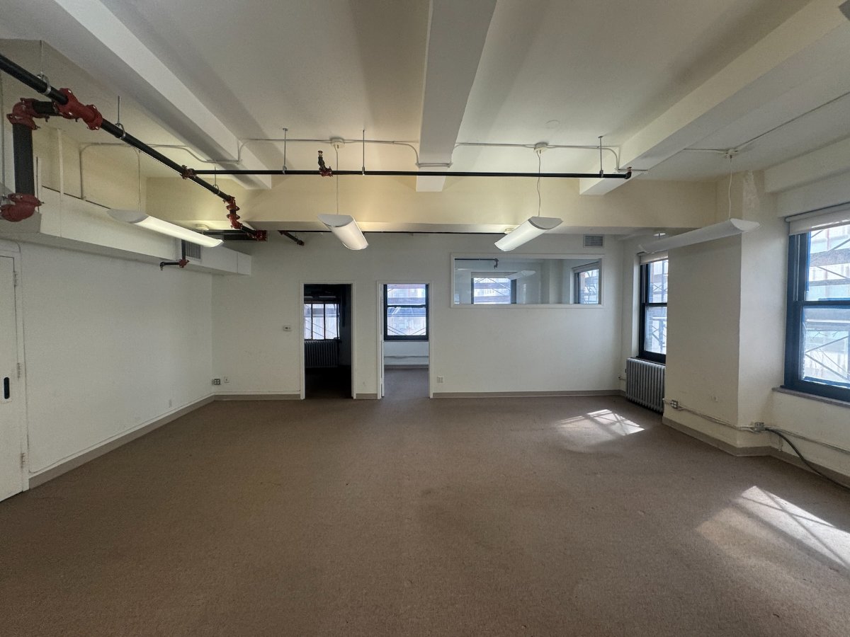 Open office space with exposed ceiling and windows, 315 Madison Avenue #1201