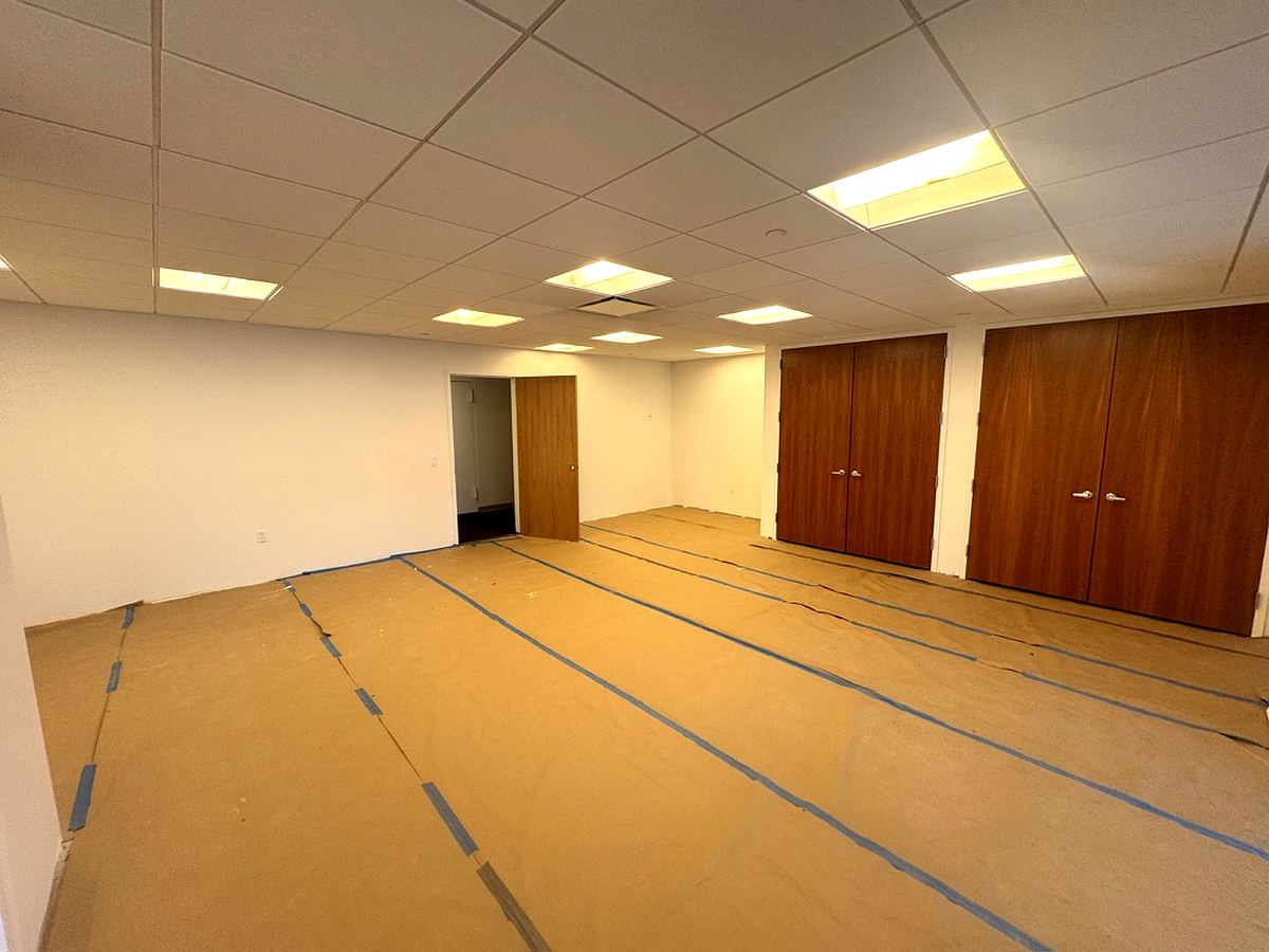 Open bullpen with wood doors under renovation, partial 37th floor at 3 Park Avenue