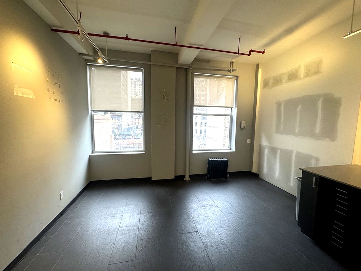 Windowed office with city views and dark tile floors, 4th floor at 7 West 30th Street
