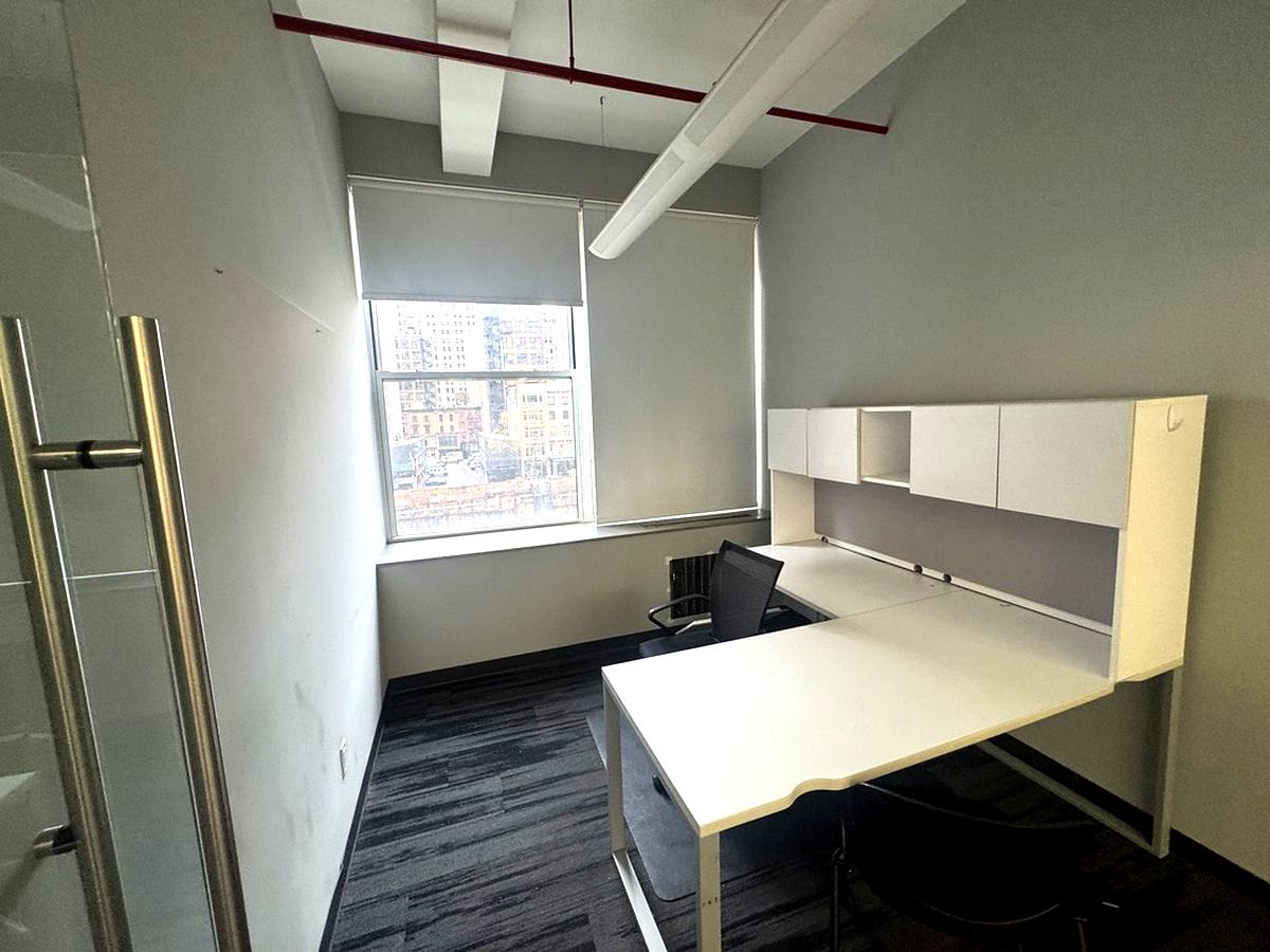 Glass-walled private office with window and built-in shelving, 4th floor at 7 West 30th Street