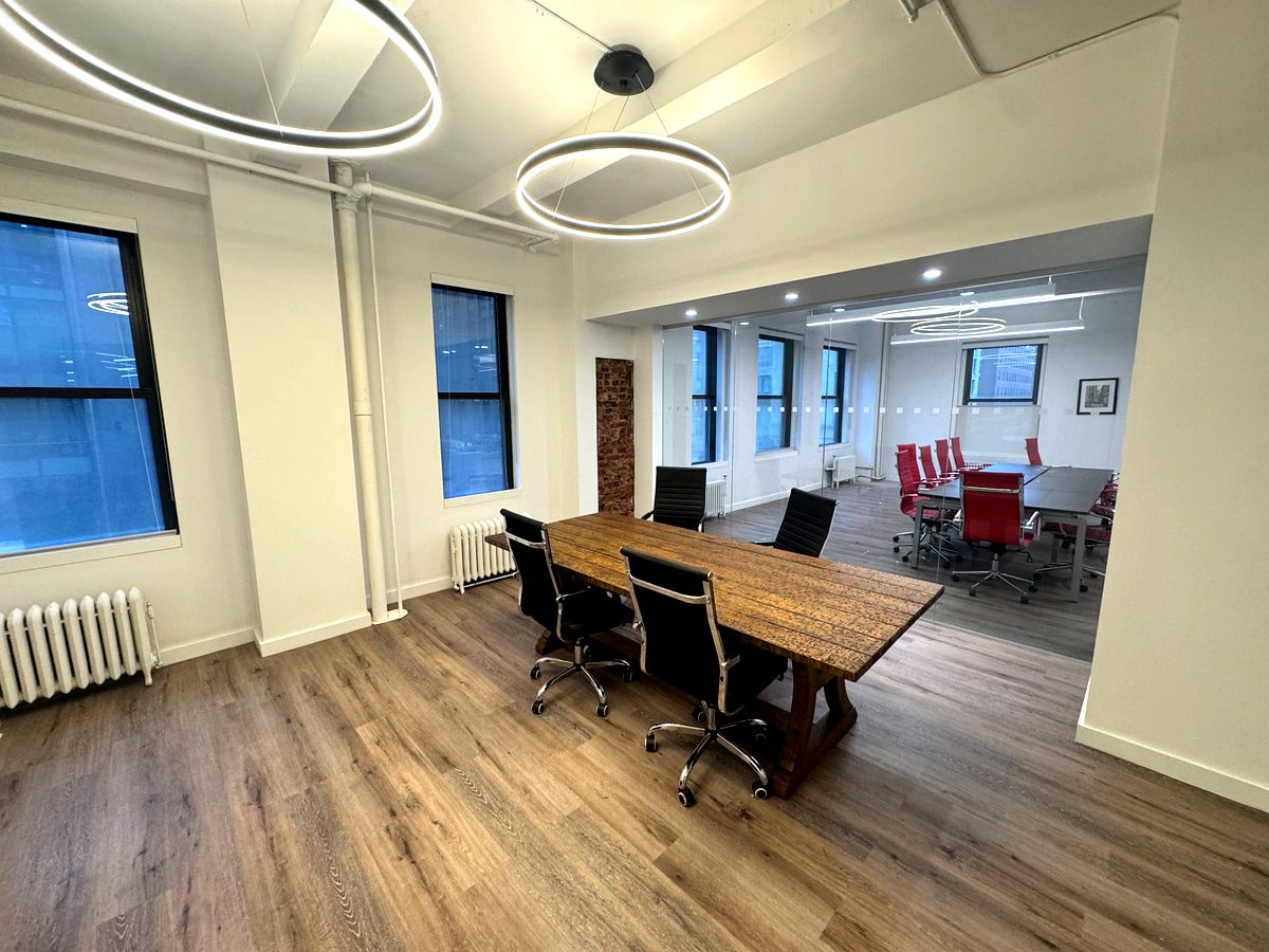 Meeting room with halo pendant lights and farm table, suite 602 at 171 Madison Avenue