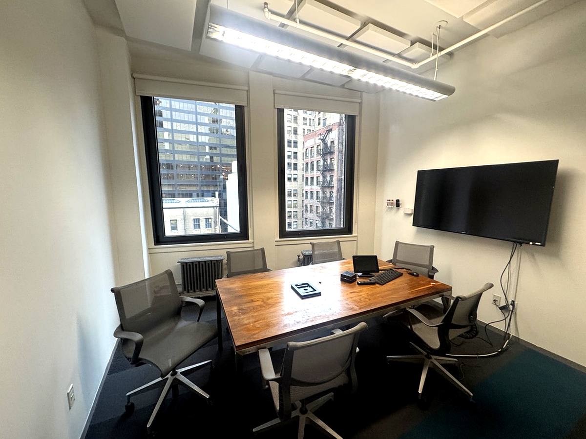 Windowed conference room with wood table and city views, 16th floor at 15 Maiden Lane