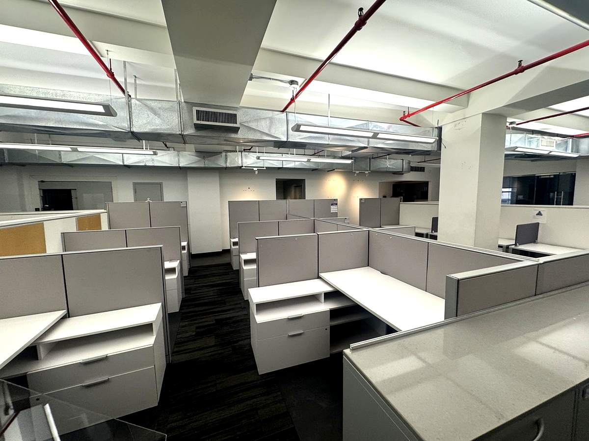 Open bullpen with cubicle workstations and exposed ceiling, 4th floor at 7 West 30th Street