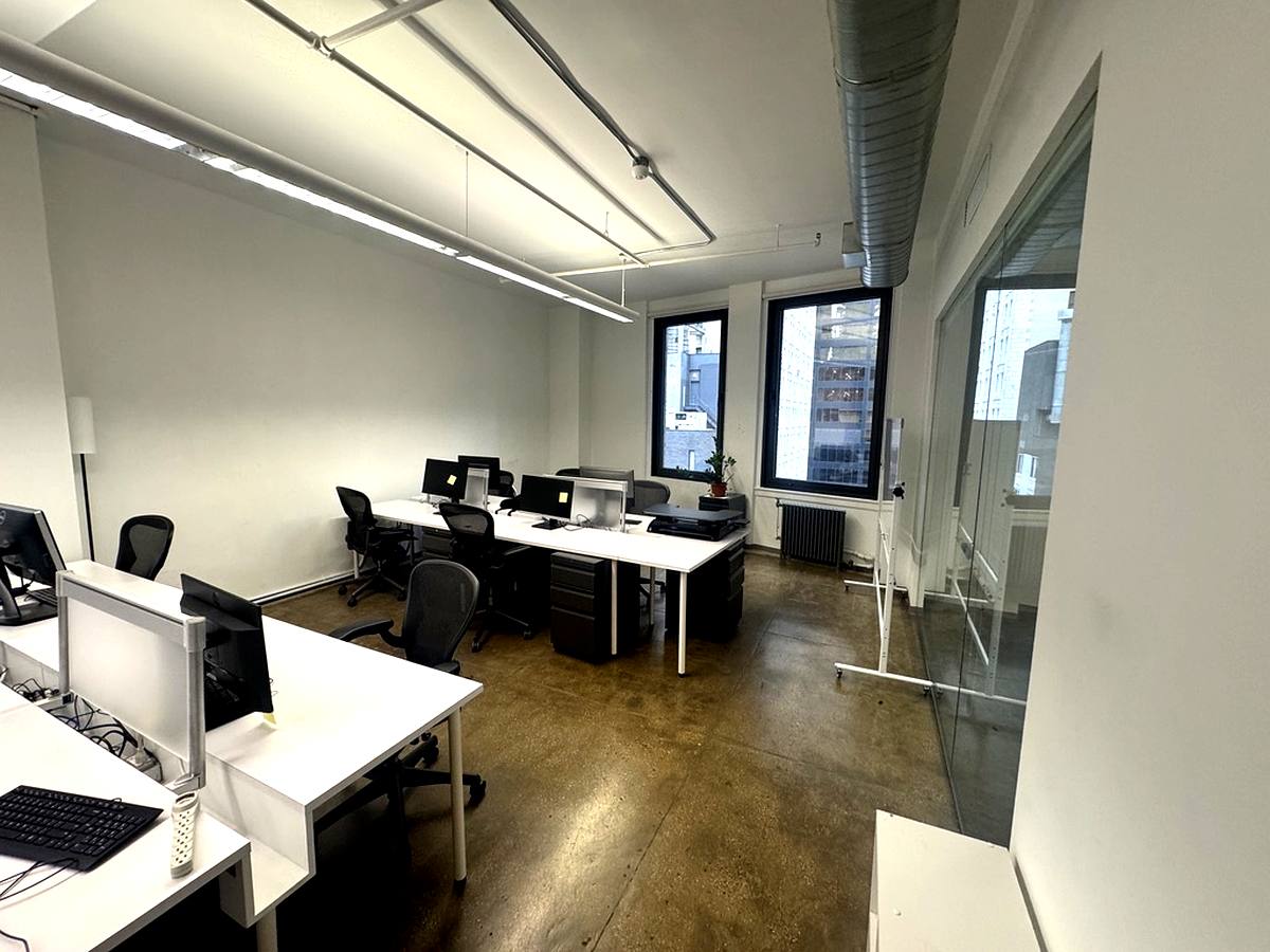 Open plan workstations with glass partition and exposed ceiling, 16th floor at 15 Maiden Lane