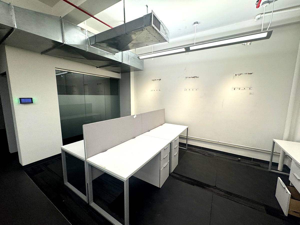 Benching workstations with glass-walled office and exposed ceiling, 4th floor at 7 West 30th Street