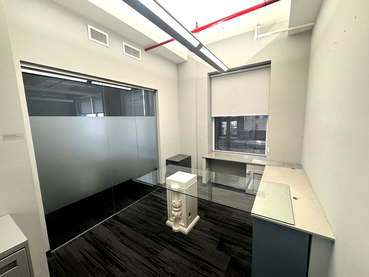 Glass-walled private office with window and built-in desk, 4th floor at 7 West 30th Street