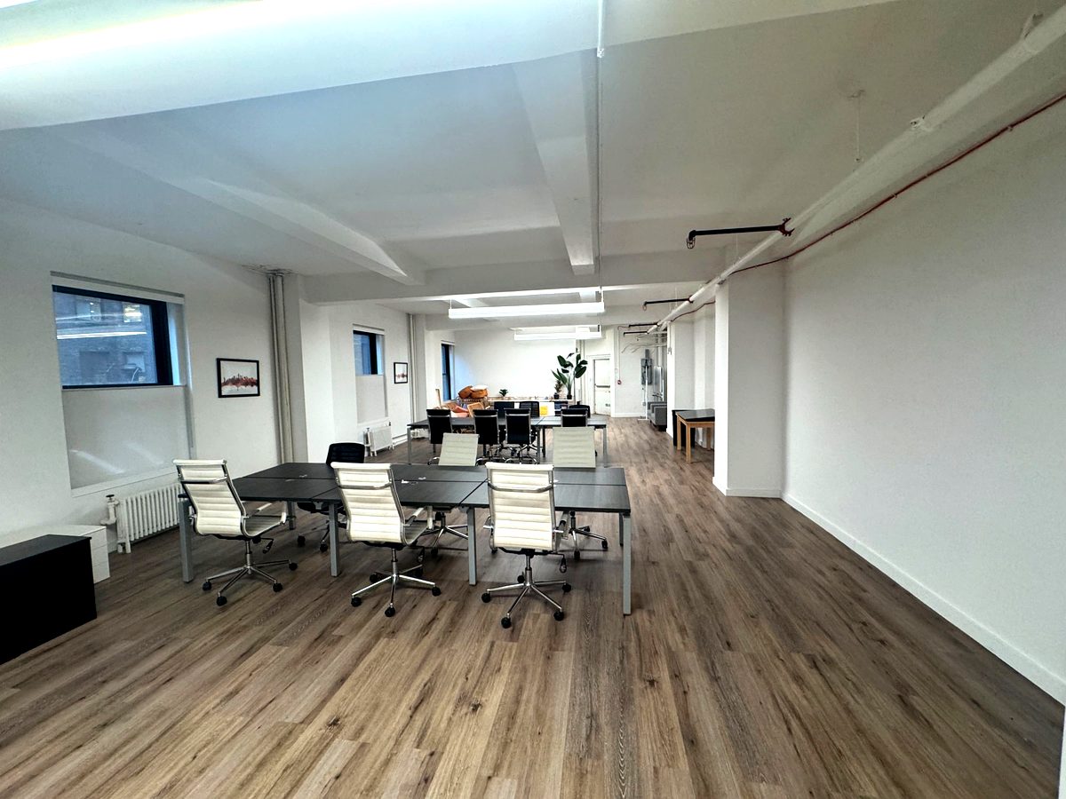 Lounge area with rattan seating and hardwood floors, suite 602 at 171 Madison Avenue