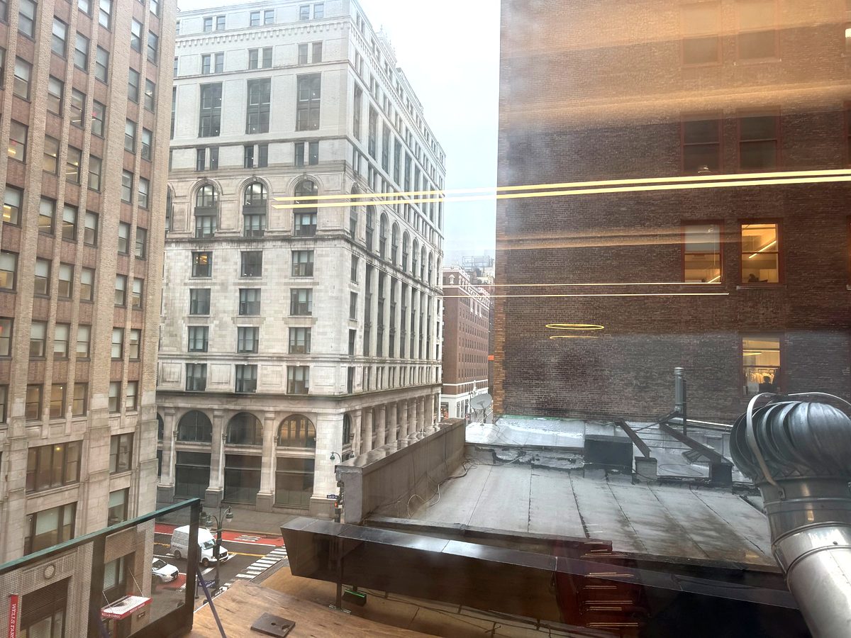 Conference area with red chairs and double window line, suite 602 at 171 Madison Avenue