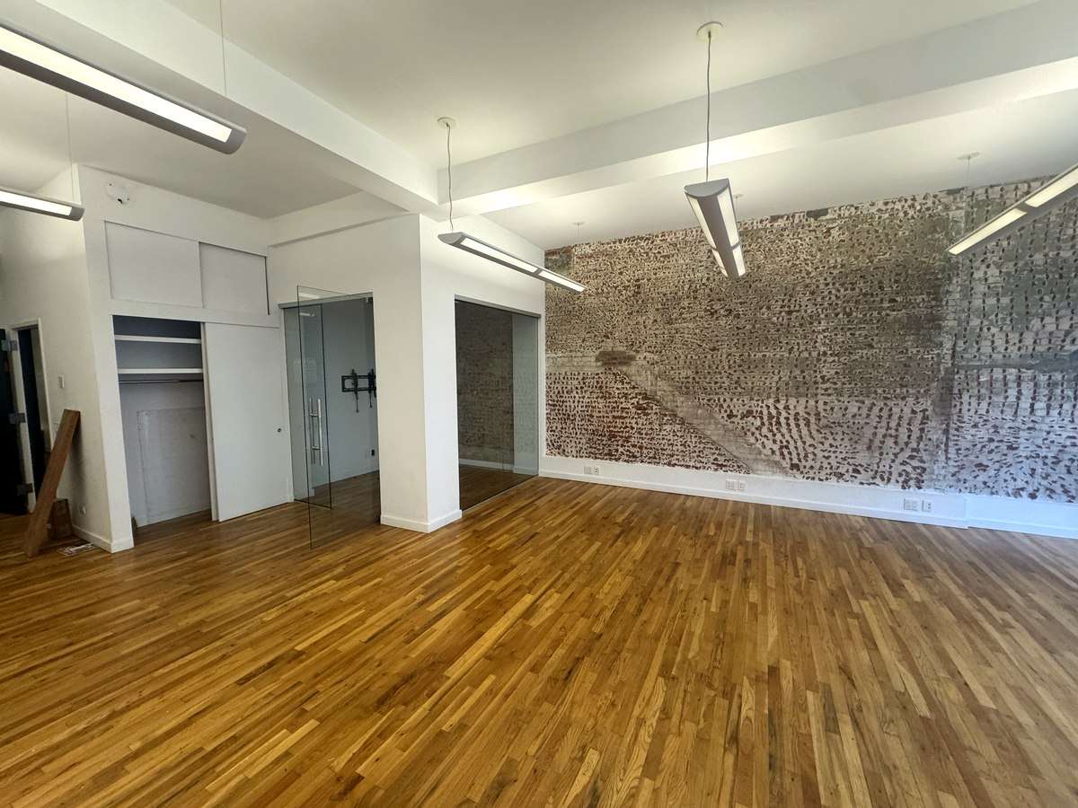Exposed brick wall beside glass-front office, Suite 2N at 420 West 14th Street