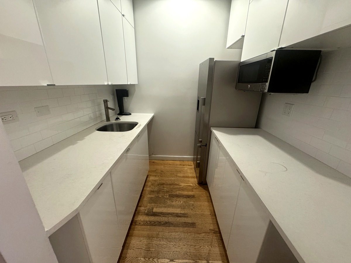 Wet pantry with sink, refrigerator and white cabinets, Suite 2N at 420 West 14th Street