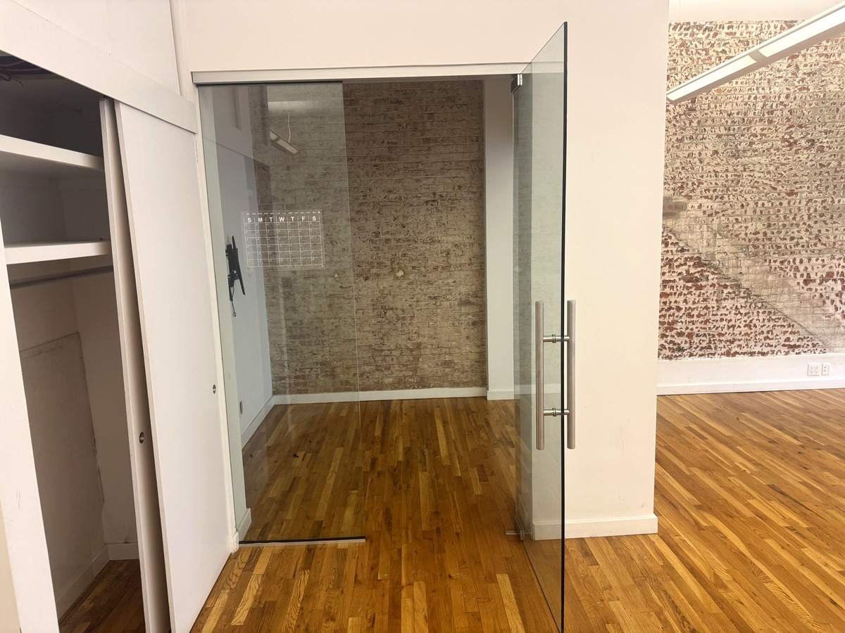 Glass-front private office with exposed brick, Suite 2N at 420 West 14th Street