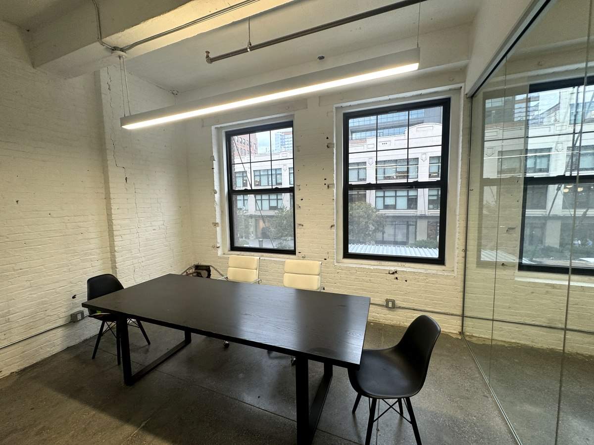Meeting table by tall windows in glass-walled room, 2nd floor at 426 West 14th Street