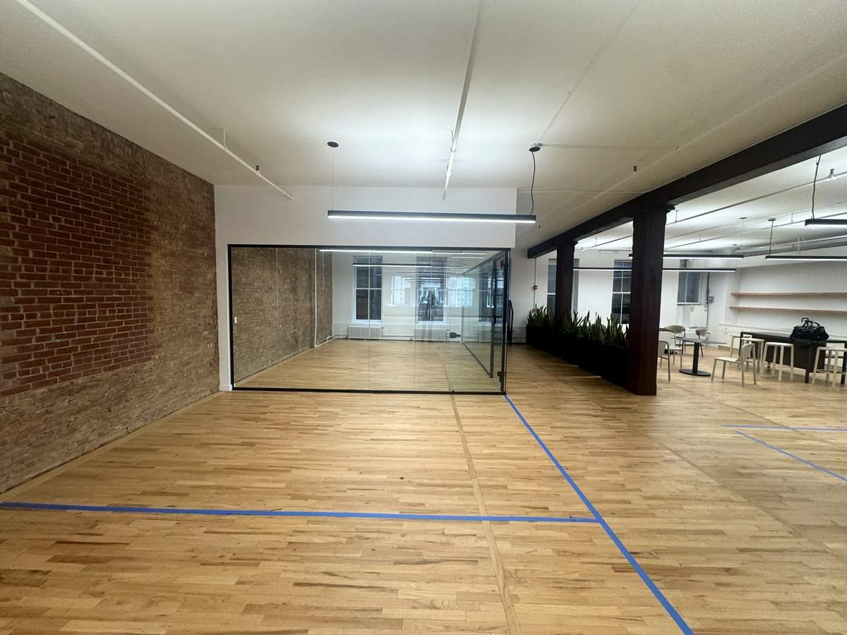 Glass-walled conference room by brick wall, partial 3rd floor at 131-133 Spring Street