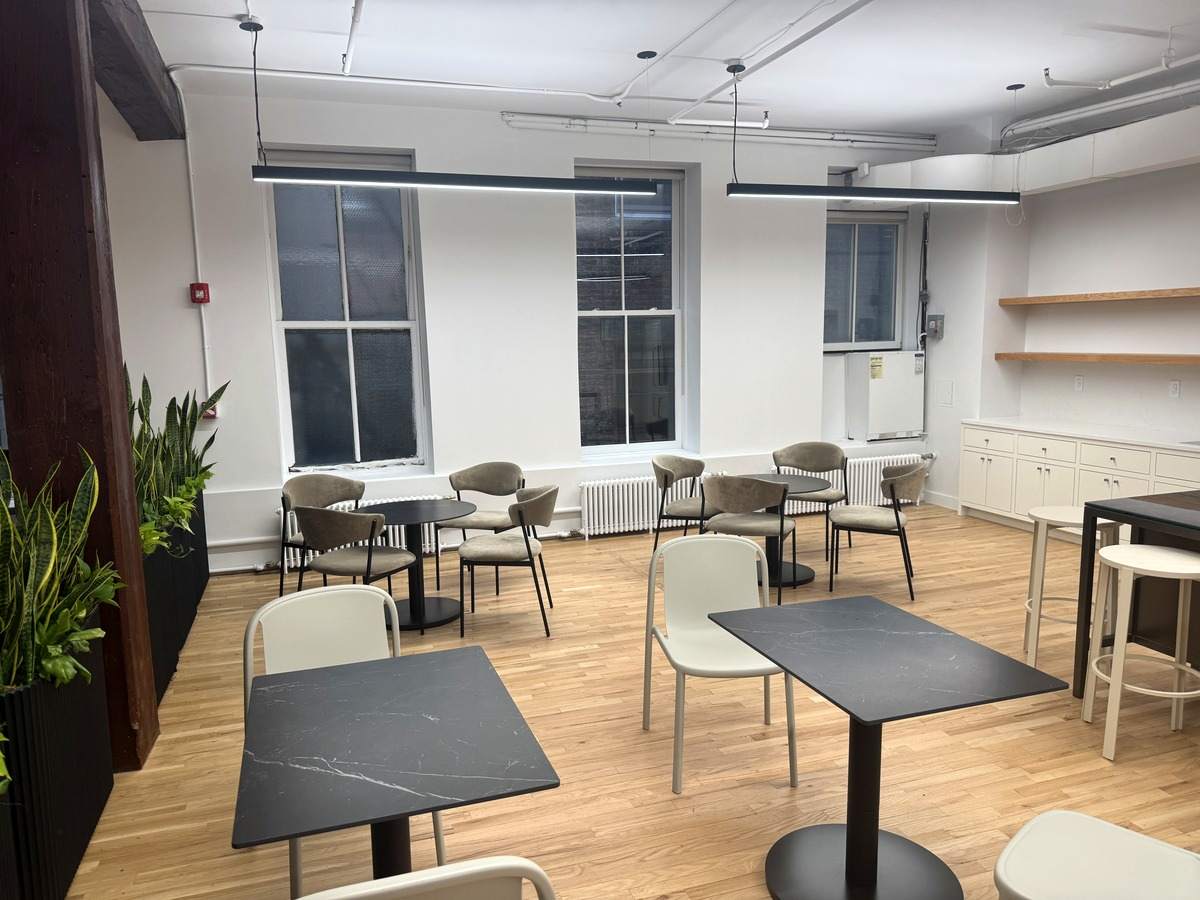 Cafe seating area beside tall windows, partial 3rd floor at 131-133 Spring Street