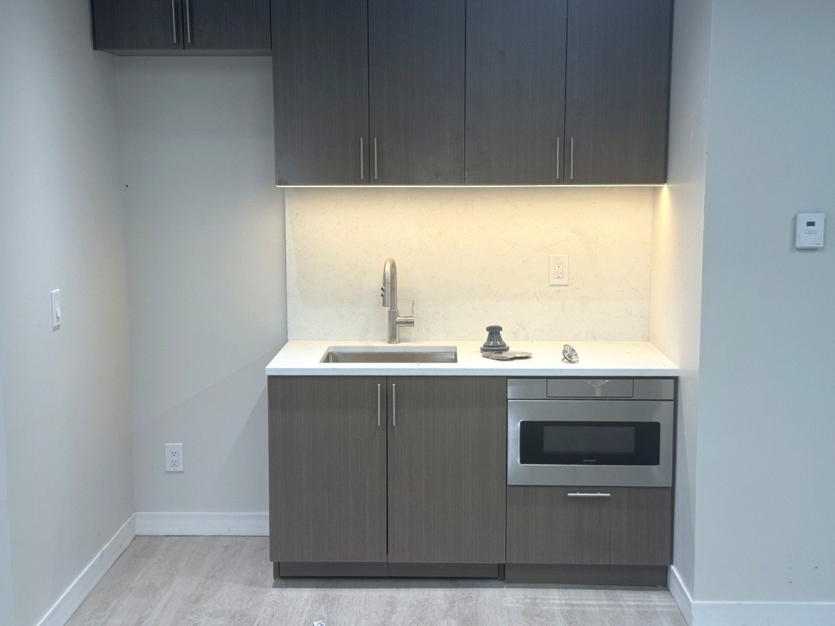 Pantry with sink, microwave and cabinets, Suite 1220 at 39 Broadway