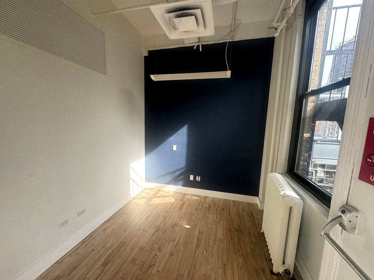 Sunlit office with navy accent wall, 10th floor at 118 West 22nd Street
