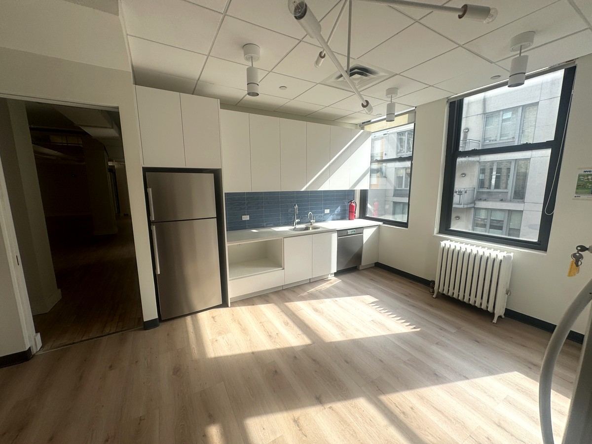 Pantry with blue tile backsplash and windows, 10th floor at 118 West 22nd Street