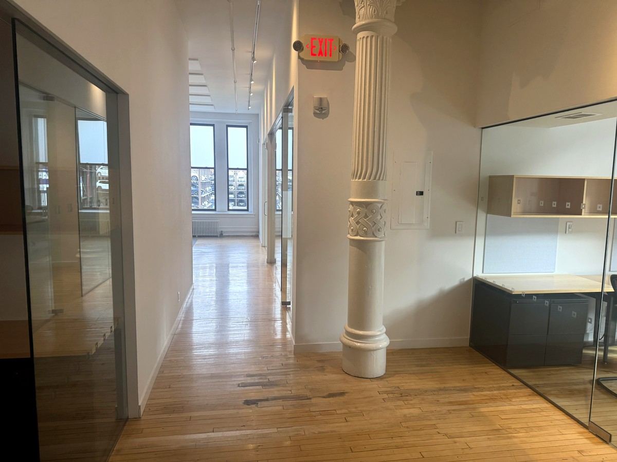Entry corridor with glass-walled offices and column, 2nd floor at 380 Lafayette Street