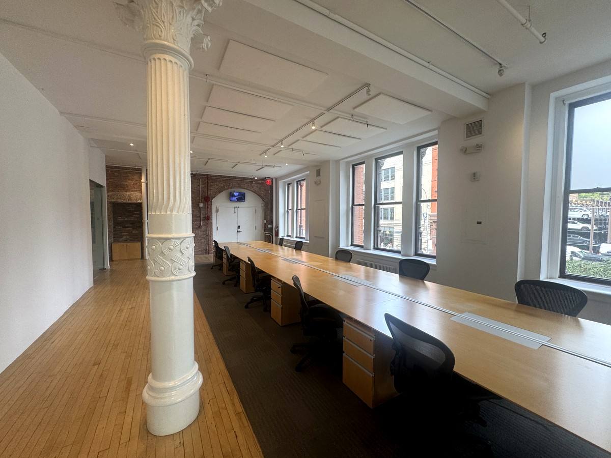 Workstations along street windows with fluted column, 2nd floor at 380 Lafayette Street