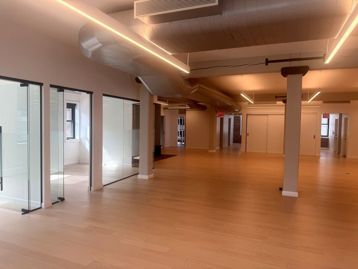 Glass-front rooms along wood floors and columns, 5th floor at 530 West 25th Street