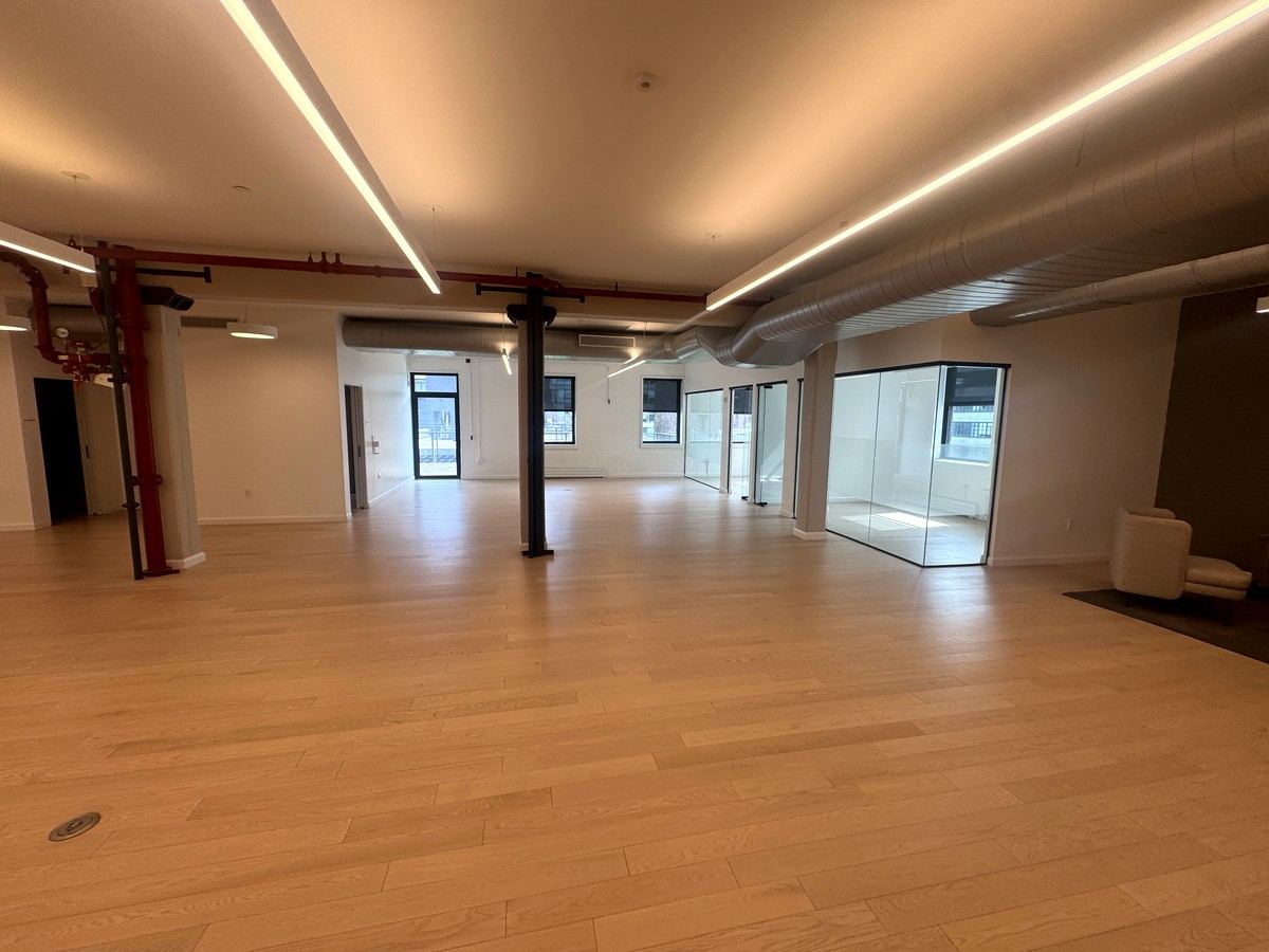 Open work area with glass-walled conference rooms, 5th floor at 530 West 25th Street