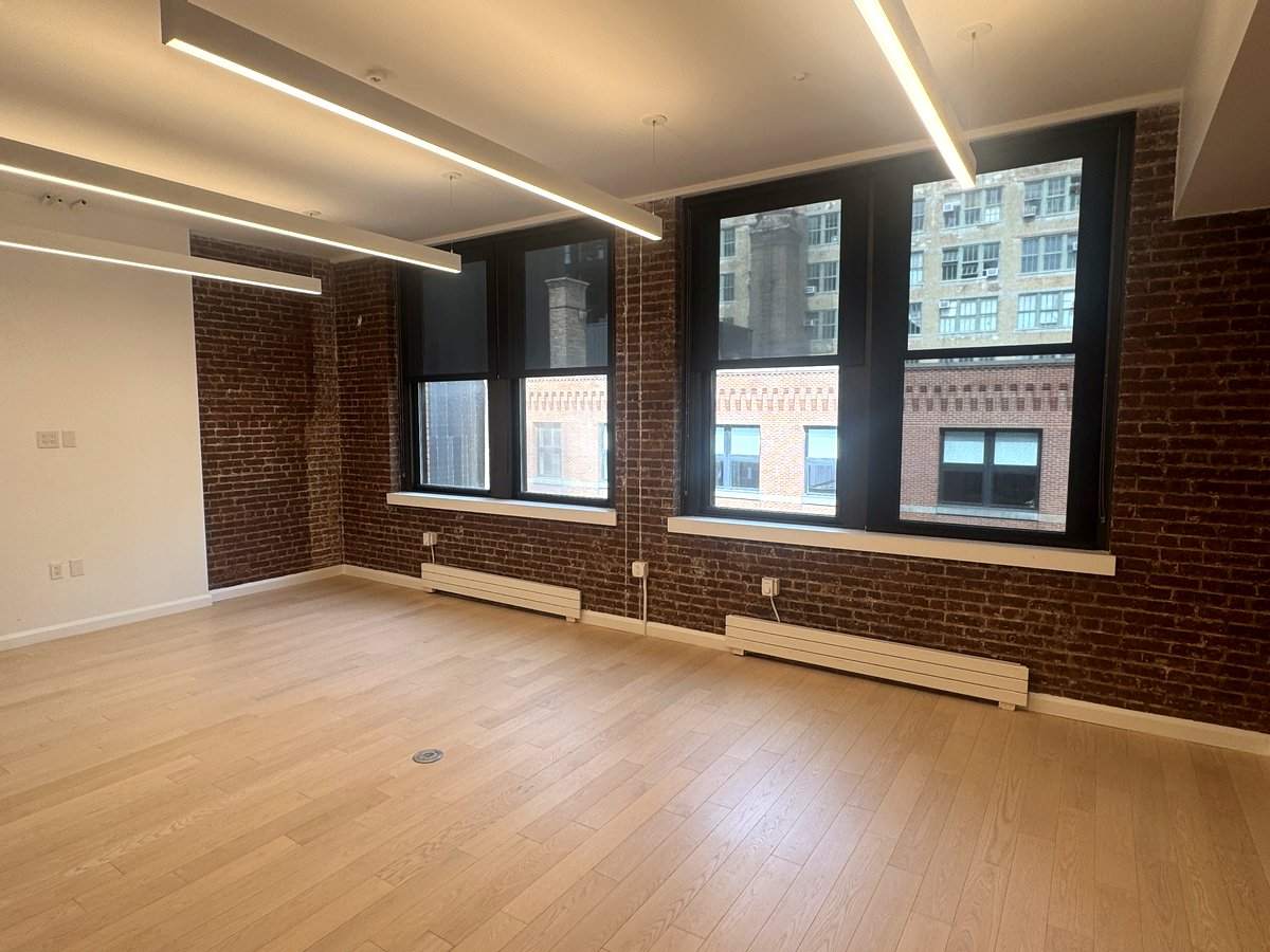 Private office with exposed brick and three windows, 5th floor at 530 West 25th Street
