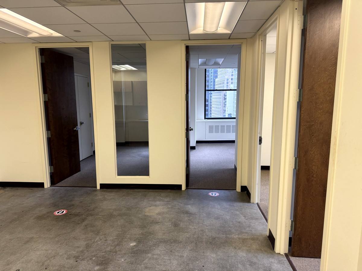 Private offices with glass sidelights off the open area, Suite 1502A at 80 Maiden Lane