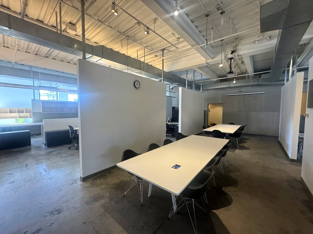 Meeting area with a large table by the windows, 4th floor at 415 West 13th Street