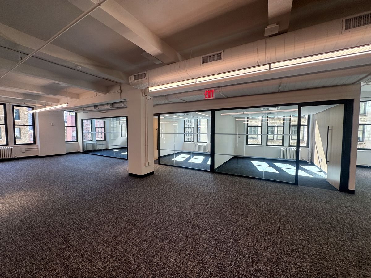 Open office area with glass-walled conference rooms and perimeter windows, 9th floor at 470 Park Avenue South