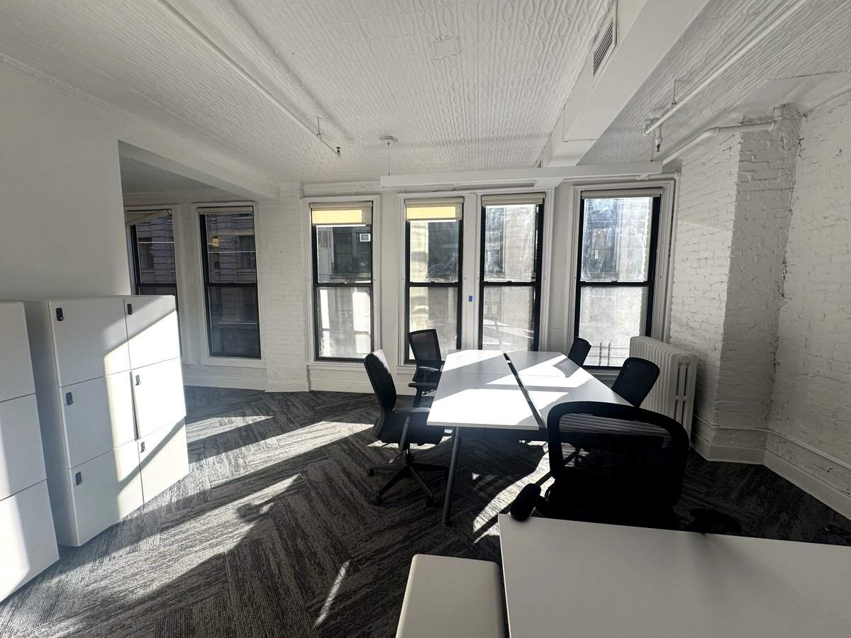 Sunlit open area with desks and lockers, 5th floor at 17 West 20th Street