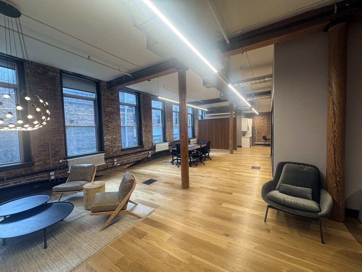 Furnished open plan office with lounge seating and conference table at 46 Greene Street